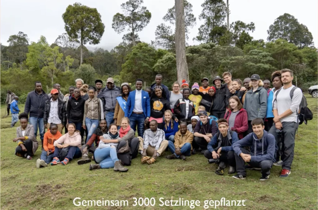 Schoolchildren from Germany and Kenya after planting 3,000 seedlings
